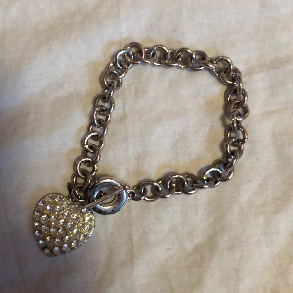 Silver charm bracelet with a jeweled heart.